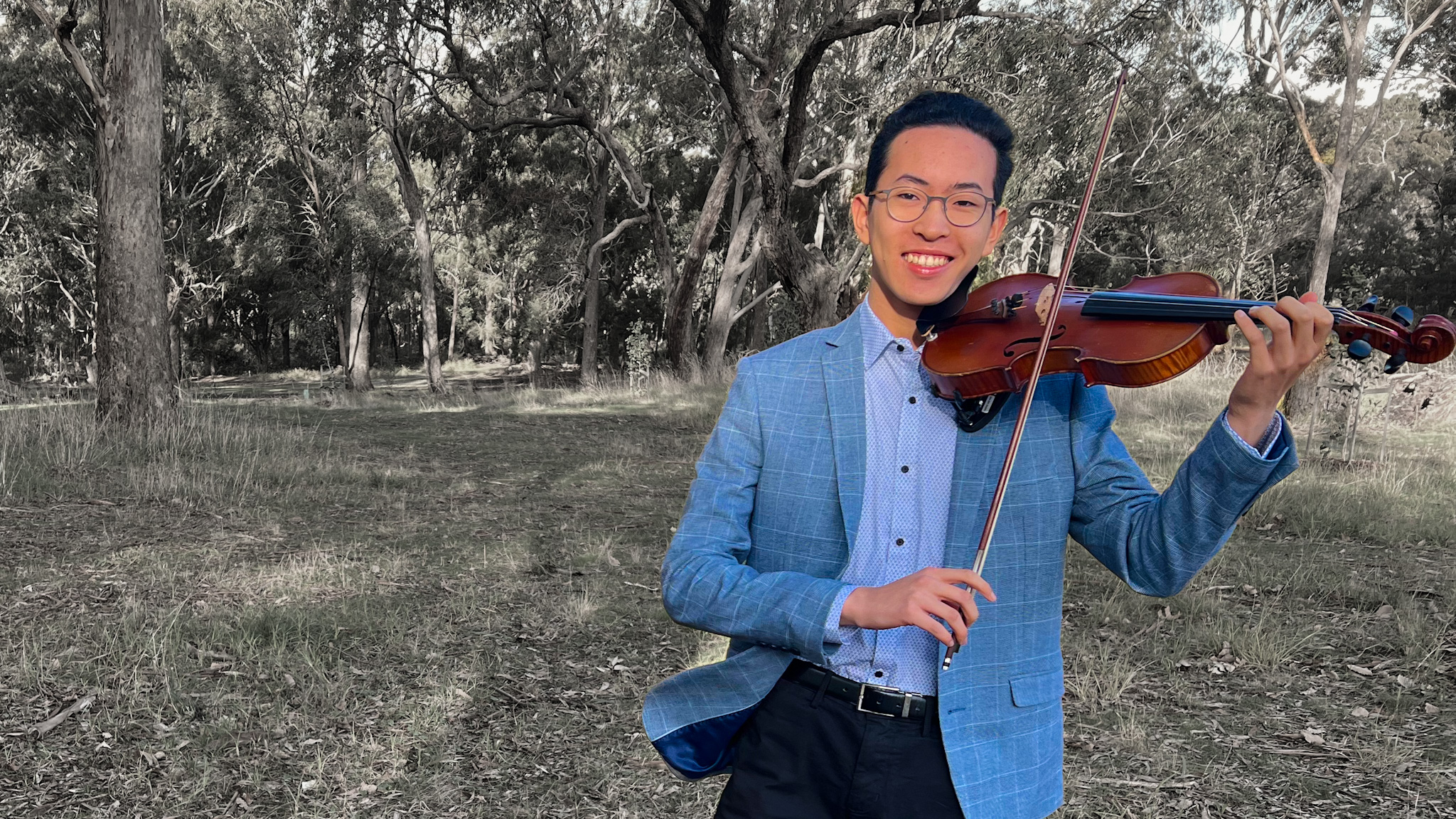 Daniel Feng, violinist playing outside a ceremony